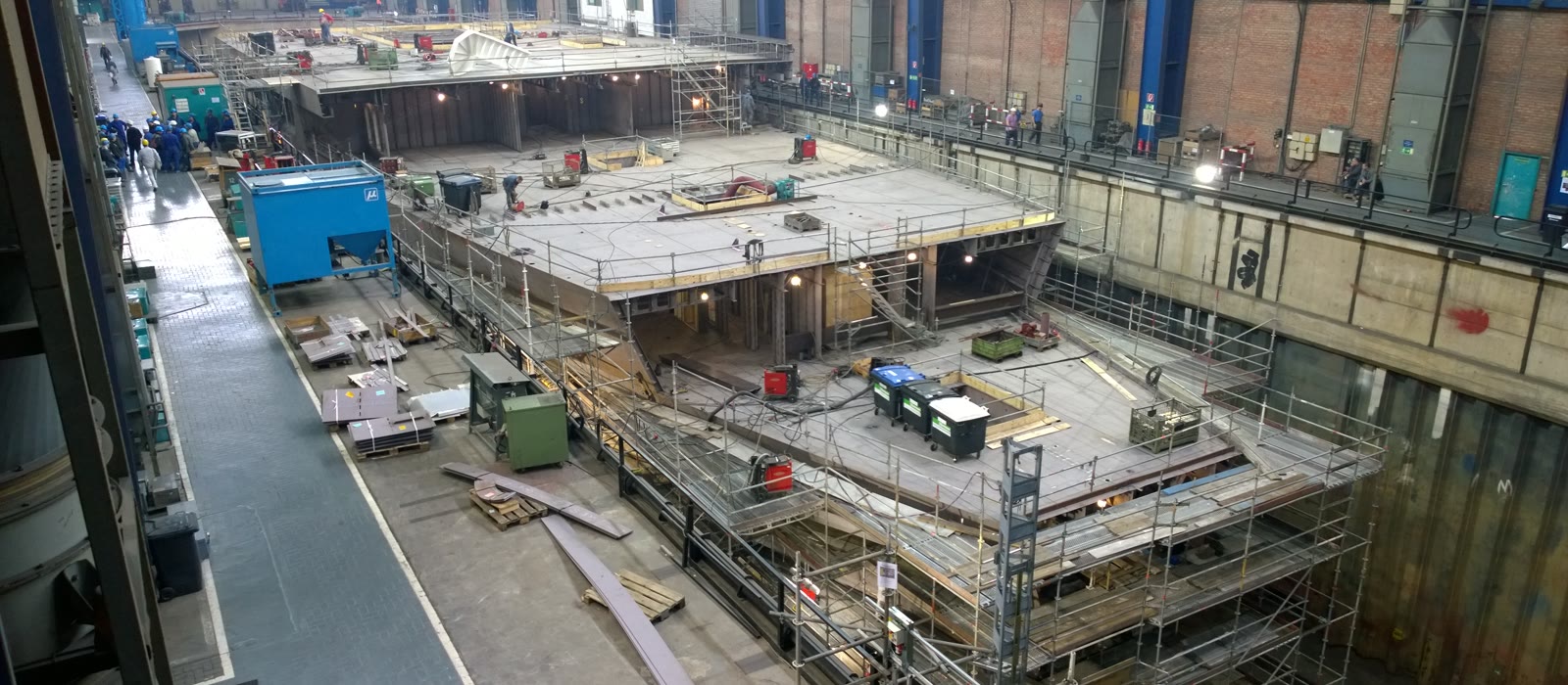 A superyacht hull under construction in a build hall
