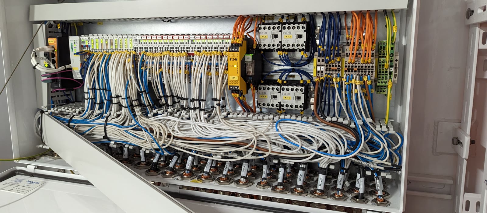 A dressed cable run inside a switchboard